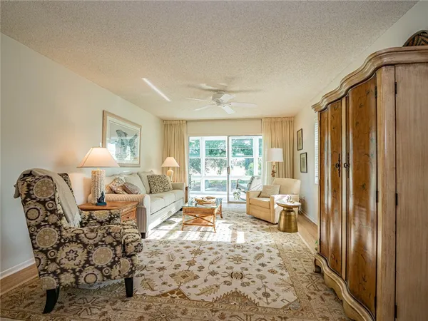 a living room with furniture window and wooden floor