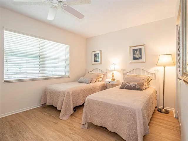 a bedroom with two beds and a window