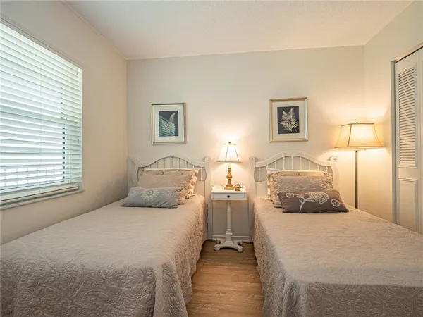 a bedroom with a bed and a night stand