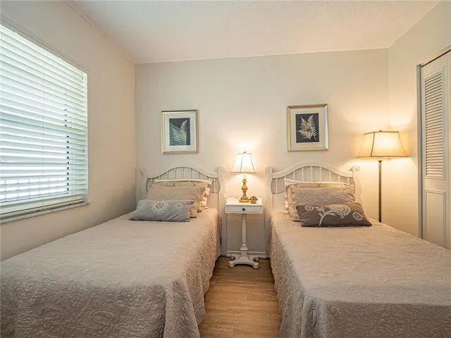 a bedroom with a bed and a night stand