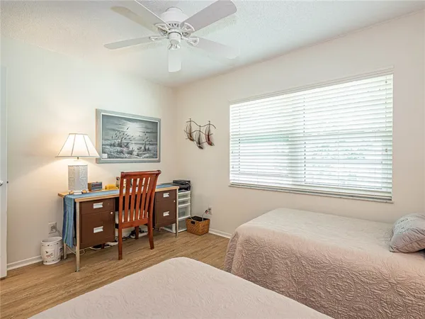 a bedroom with a bed a desk and chair