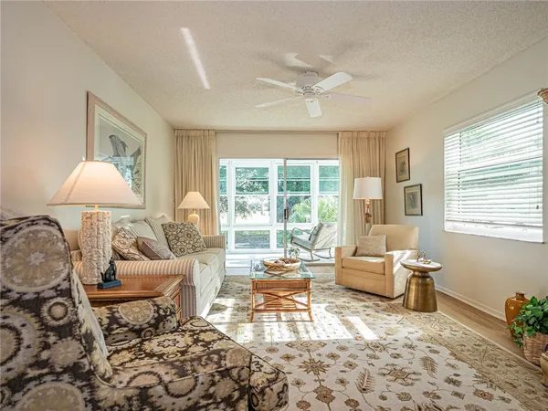 a living room with furniture and a lamp