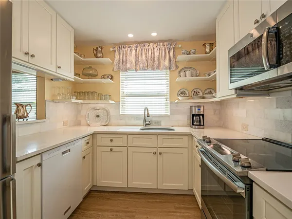 a kitchen with a sink stove and cabinets