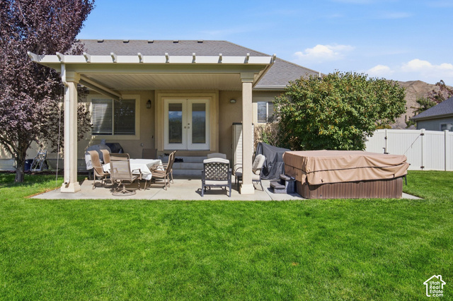 1447 Meadow Lane Mapleton, UT 84664 - Photo 41 of 67 Expansive backyard featuring a covered patio, concrete hardscaping, and a white vinyl fence