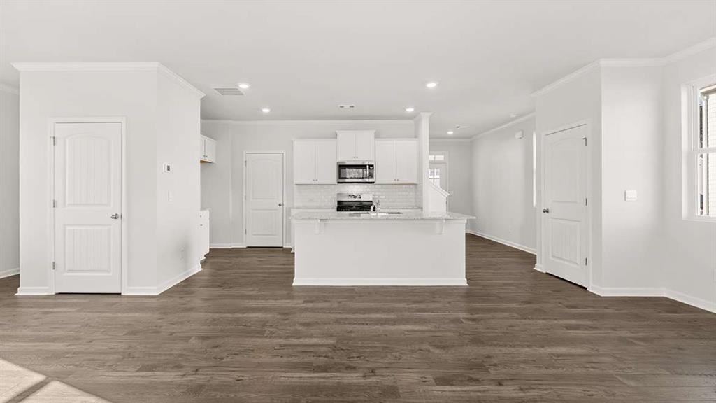 a view of kitchen view wooden cabinets and refrigerator