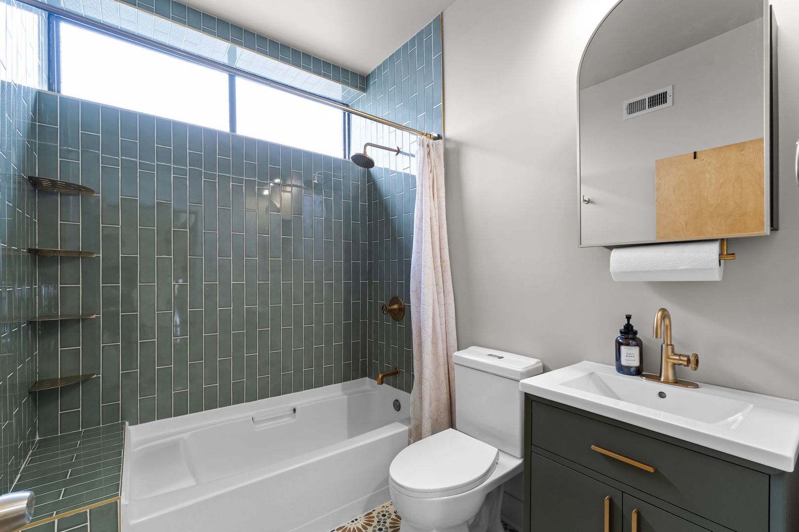 7349 Madison Street, Unit E Forest Park, IL 60130 - Photo 14 of 17 a bathroom with a bathtub shower sink vanity mirror and toilet