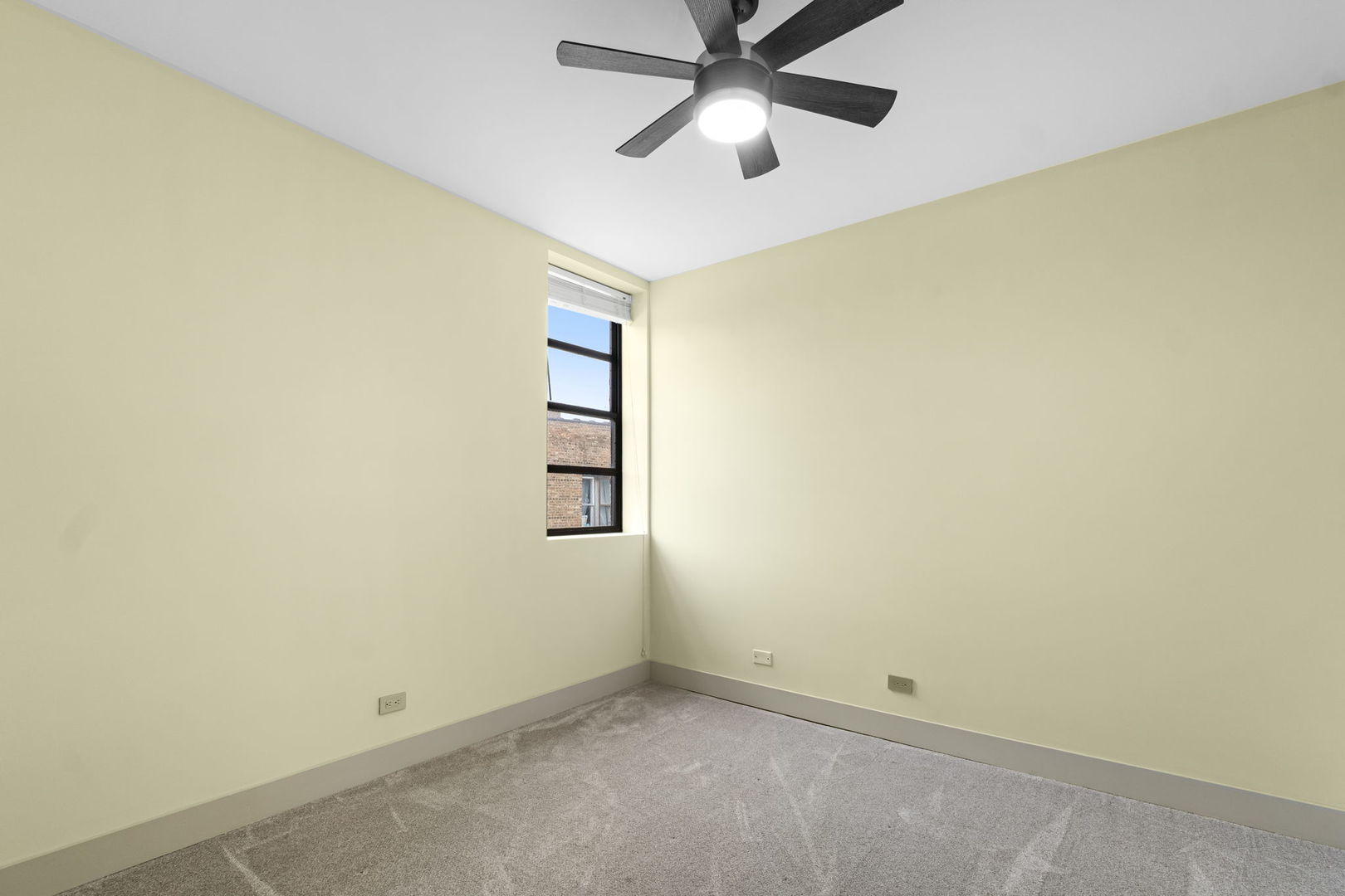 7349 Madison Street, Unit E Forest Park, IL 60130 - Photo 10 of 17 an empty room with a window and a fan