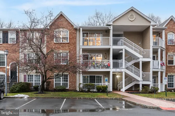 a front view of a residential apartment building with a yard