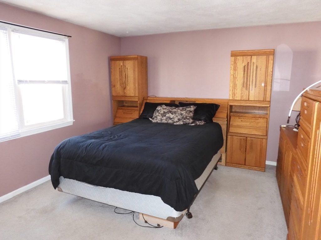 115 Merrimack Road, Unit 115 Methuen, MA 01844 - Photo 13 of 23 a bedroom with a bed and a window