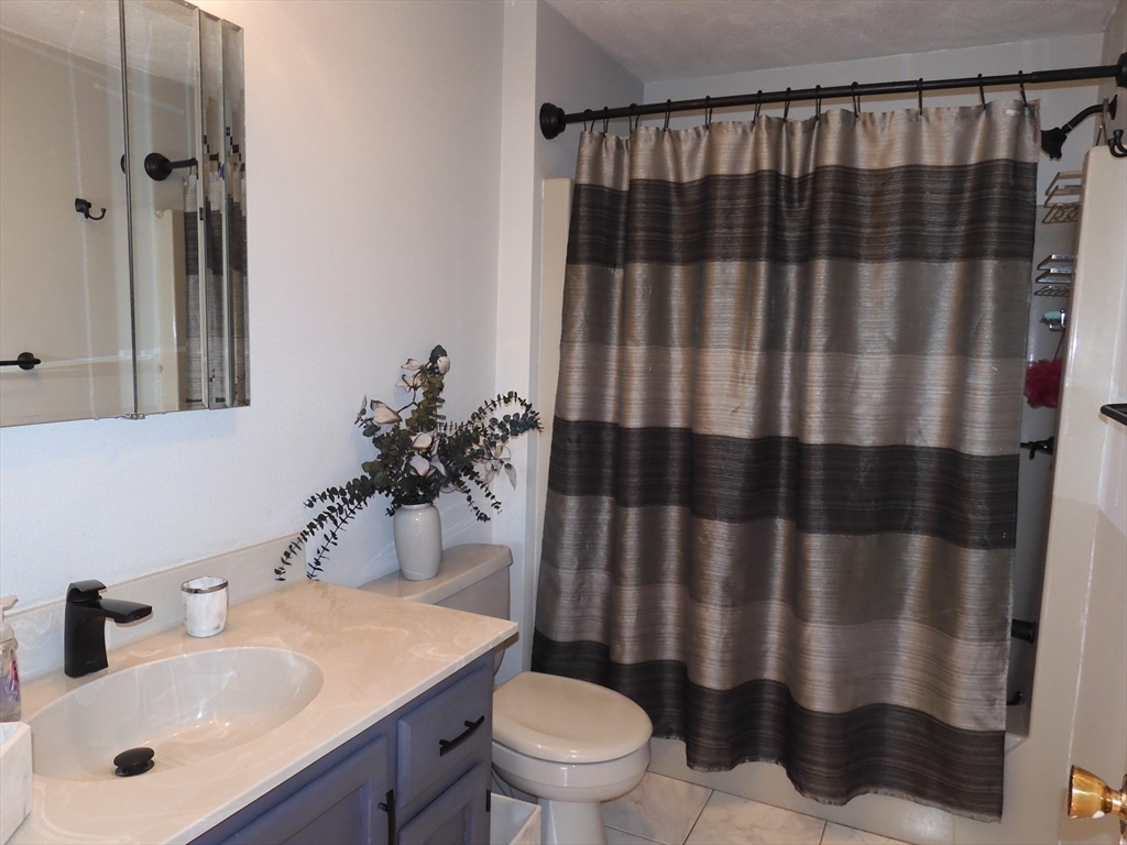 115 Merrimack Road, Unit 115 Methuen, MA 01844 - Photo 15 of 23 a bathroom with a sink toilet and shower