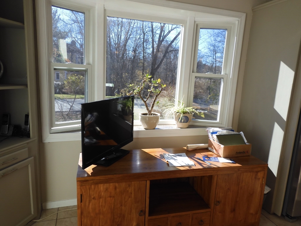115 Merrimack Road, Unit 115 Methuen, MA 01844 - Photo 10 of 23 a living room with a table chairs and a window