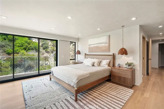 a spacious bedroom with a large bed and a flat screen tv