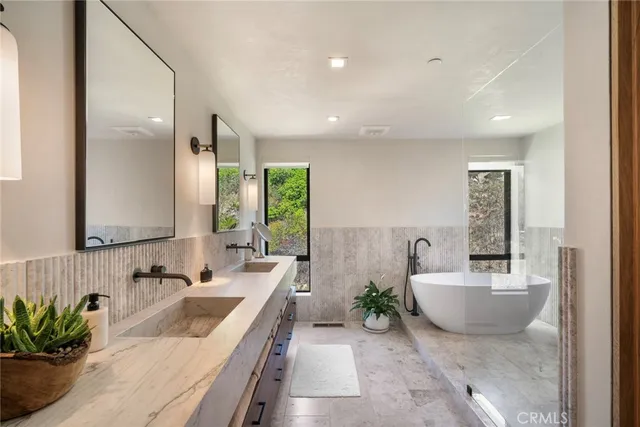 a bathroom with a double vanity sink and a mirror