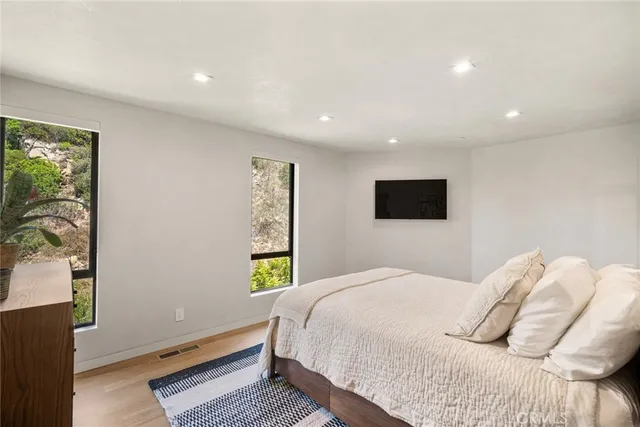 a bedroom with a bed and a flat screen tv