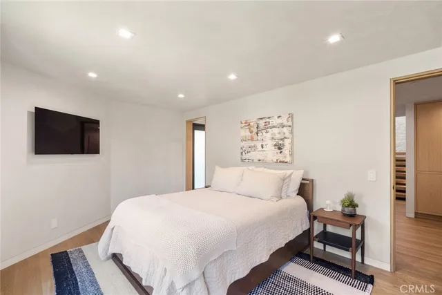 a bedroom with a large bed and a large window