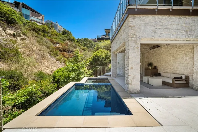 a view of a balcony with couches and potted plants