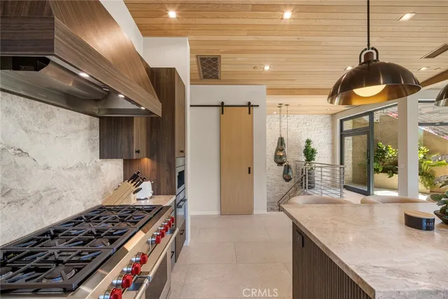 a kitchen with stainless steel appliances granite countertop a stove and a sink