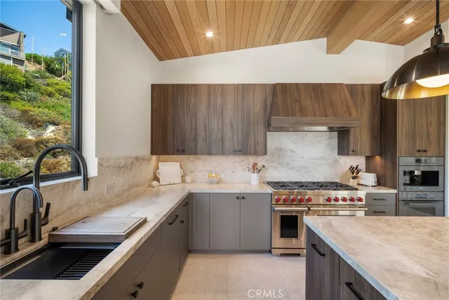 a kitchen with a sink stove and cabinets