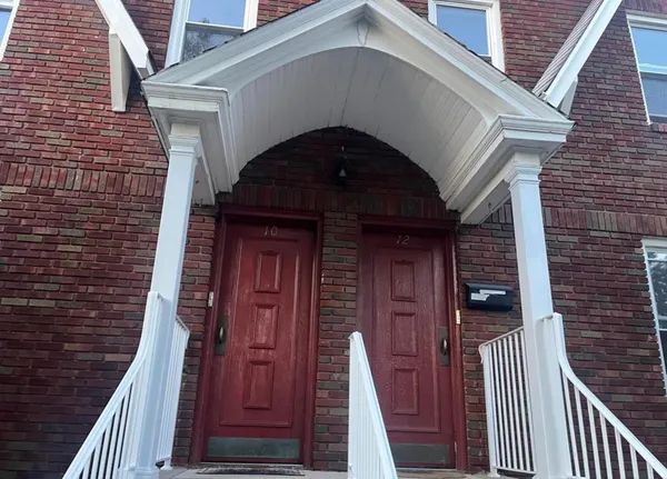 a front view of a house with wooden stairs