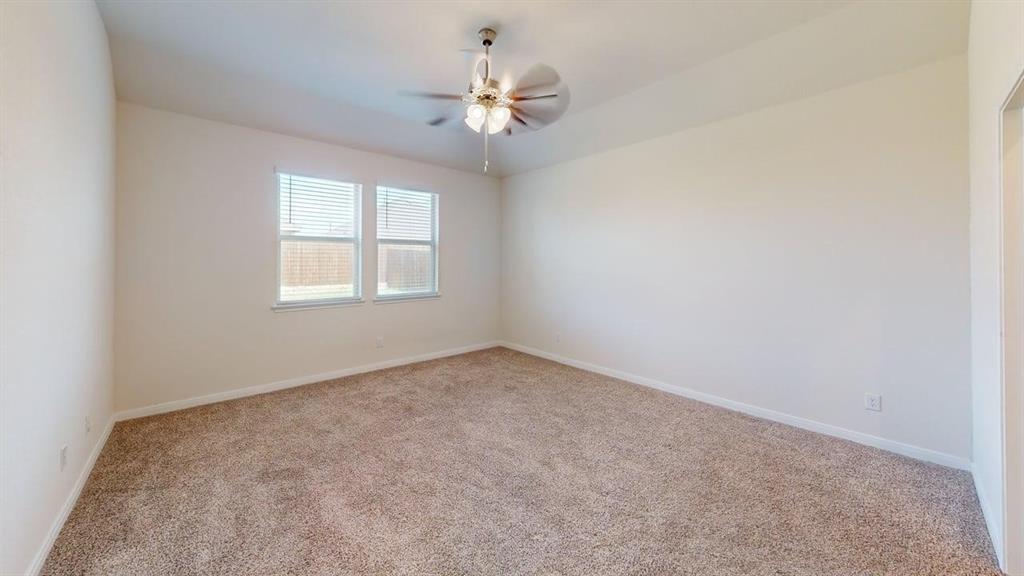 1306 Colonial Bluff Lane Princeton, TX 75407 - Photo 11 of 27 Spacious room featuring neutral carpeting, light-colored walls, and a ceiling fan with integrated lighting