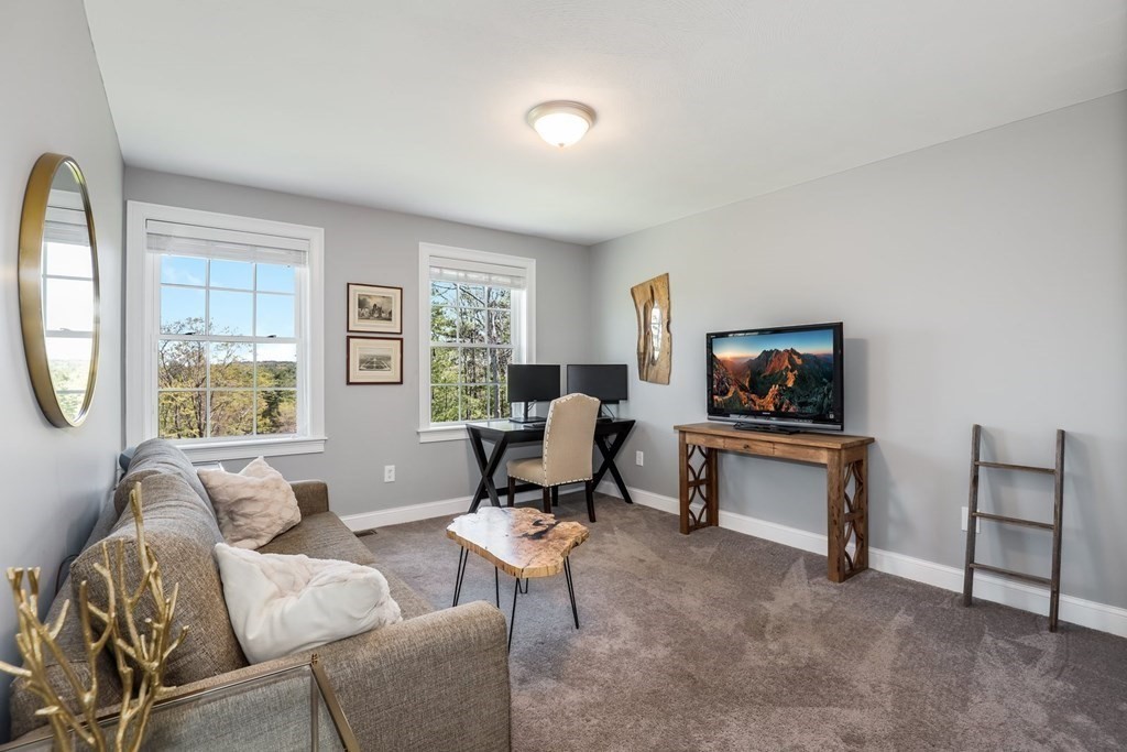 2 Budnick Way Boxford, MA 01921 - Photo 22 of 41 a living room with furniture a window and a flat screen tv