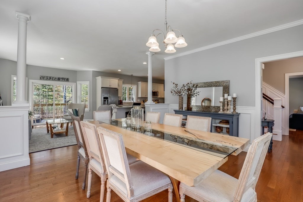 2 Budnick Way Boxford, MA 01921 - Photo 8 of 41 a dining room with wooden floor a chandelier a wooden table and chairs