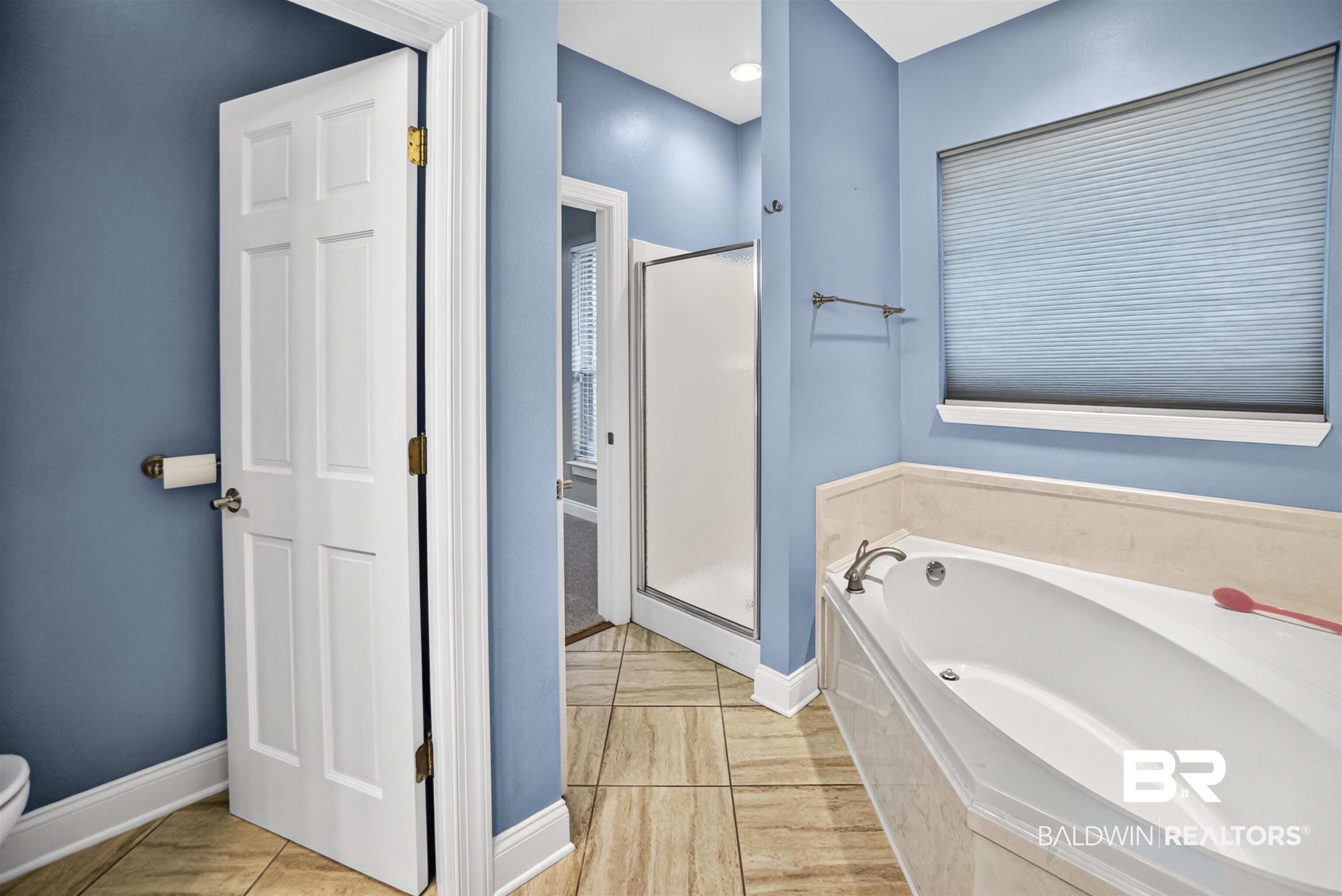 5913 Antoine Road Mobile, AL 36693 - Photo 13 of 33 Full-size soaking tub with integrated surround, accompanied by a separate glass-enclosed shower
