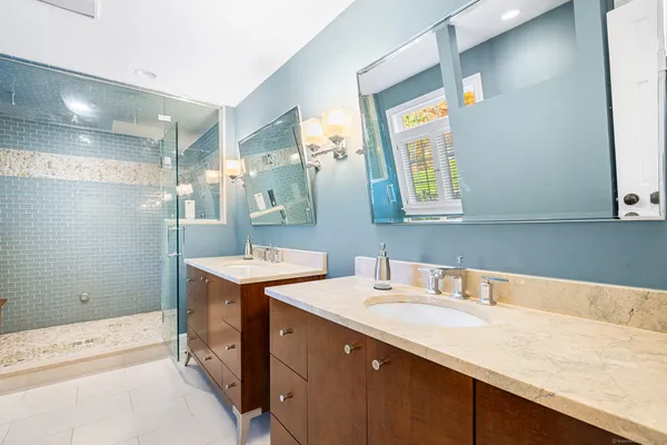 a bathroom with a sink double vanity and a mirror