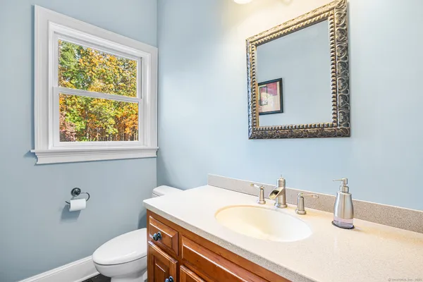 a bathroom with a toilet sink and mirror