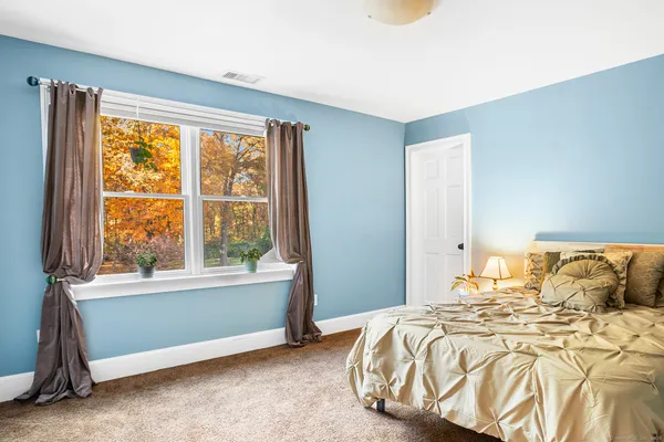 a bedroom with a bed and a window