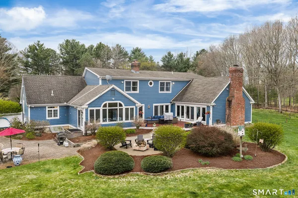 an aerial view of a house with swimming pool and sitting area