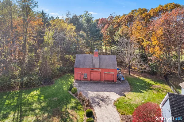 a backyard of a house with table and chairs