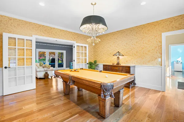 a room with pool table and windows