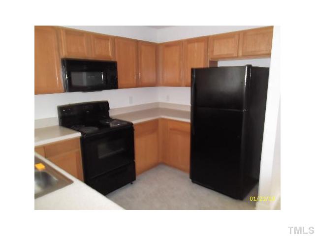 1444 Ricochet Drive Raleigh, NC 27610 - Photo 3 of 8 a kitchen with a refrigerator stove and microwave