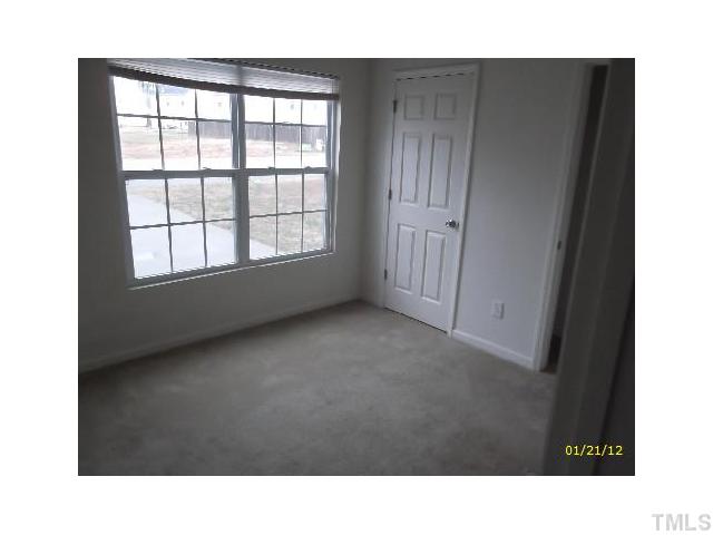 1444 Ricochet Drive Raleigh, NC 27610 - Photo 5 of 8 a open hall with a floor to ceiling window