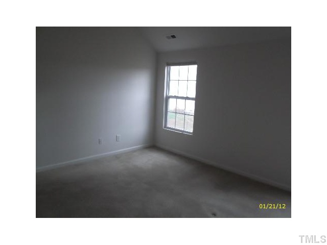 1444 Ricochet Drive Raleigh, NC 27610 - Photo 7 of 8 a black and white photo of a living room