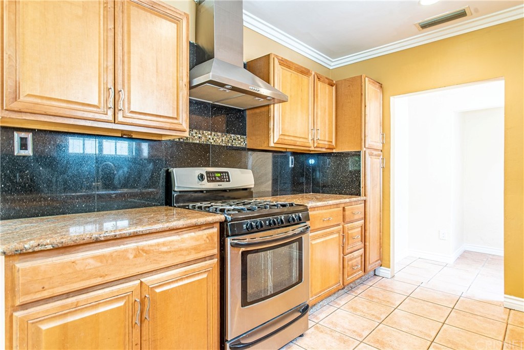 6839 Tampa Avenue Reseda, CA 91335 - Photo 12 of 48 a kitchen with granite countertop a stove and a sink
