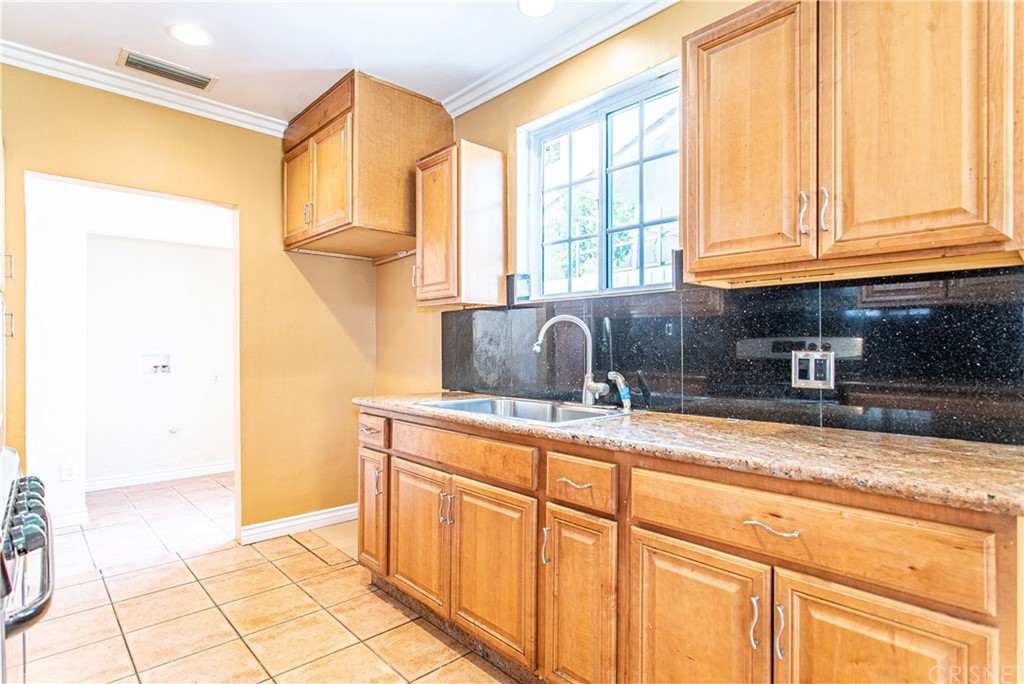 6839 Tampa Avenue Reseda, CA 91335 - Photo 13 of 48 a kitchen with stainless steel appliances granite countertop a sink and a cabinets