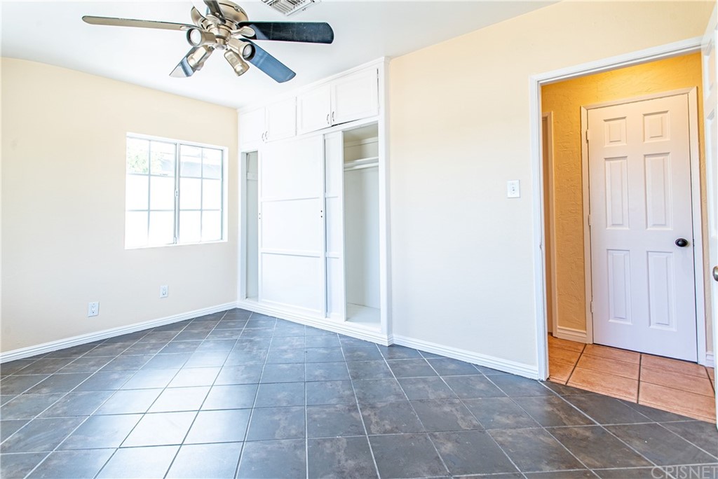6839 Tampa Avenue Reseda, CA 91335 - Photo 26 of 48 an empty room with windows and chandelier fan