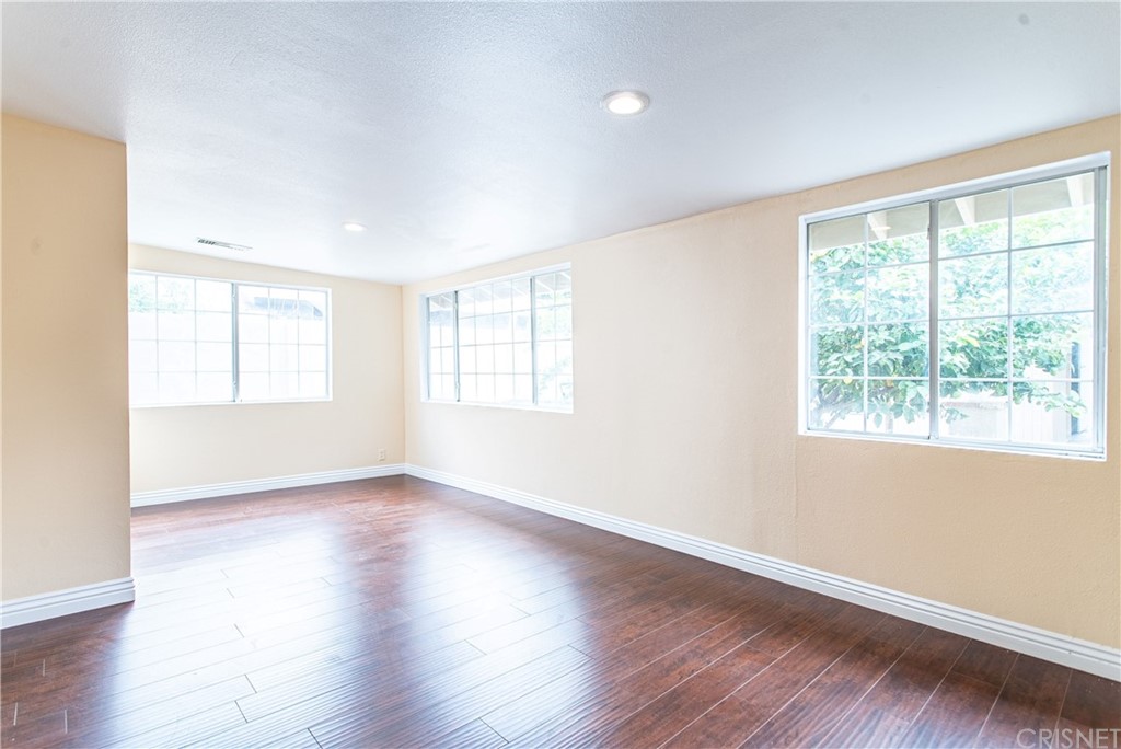 6839 Tampa Avenue Reseda, CA 91335 - Photo 32 of 48 a view of an empty room with wooden floor and a window