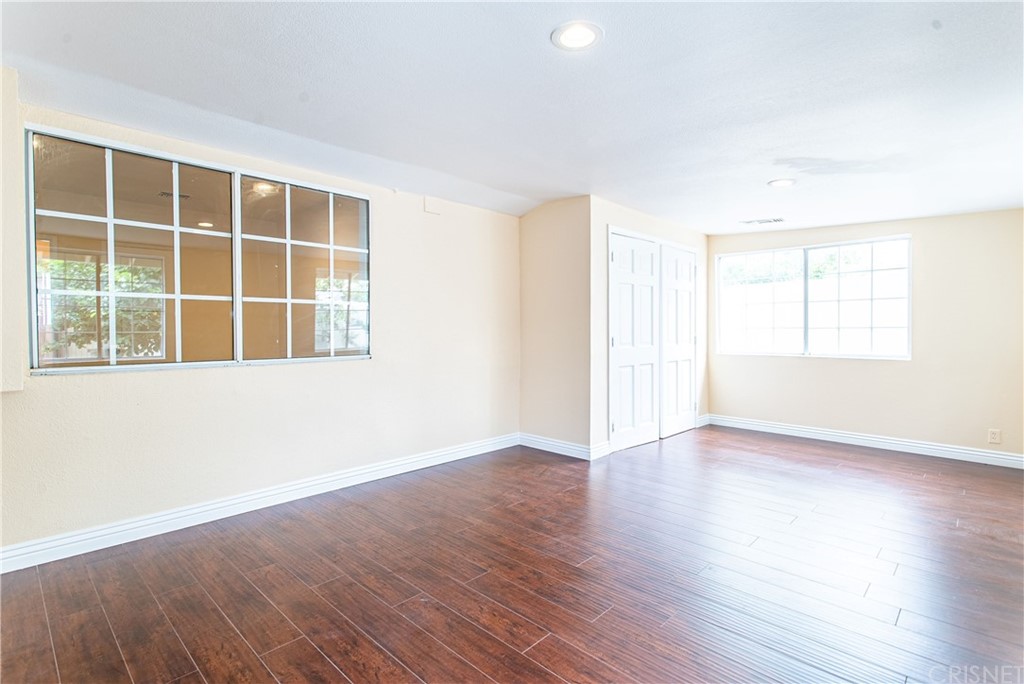 6839 Tampa Avenue Reseda, CA 91335 - Photo 33 of 48 an empty room with wooden floor and windows