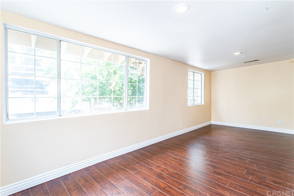 6839 Tampa Avenue Reseda, CA 91335 - Photo 34 of 48 a view of an empty room with wooden floor and a window
