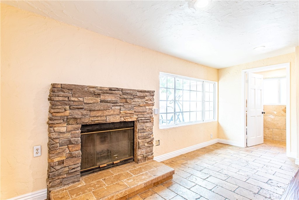 6839 Tampa Avenue Reseda, CA 91335 - Photo 35 of 48 a living room with a fireplace furniture a rug and a window
