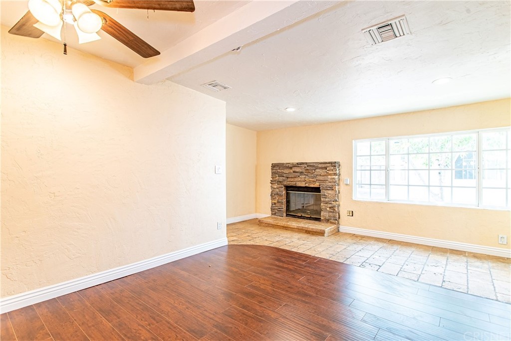 6839 Tampa Avenue Reseda, CA 91335 - Photo 38 of 48 a view of a livingroom with wooden floor and a fireplace