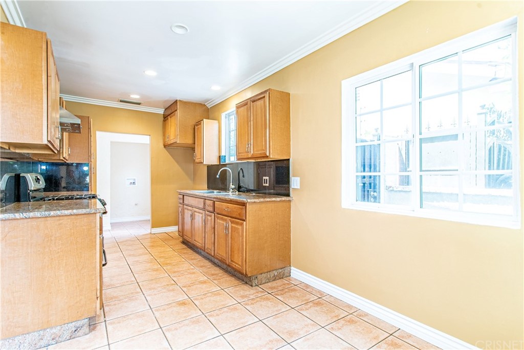 6839 Tampa Avenue Reseda, CA 91335 - Photo 10 of 48 a kitchen with stainless steel appliances granite countertop a refrigerator and a stove top oven