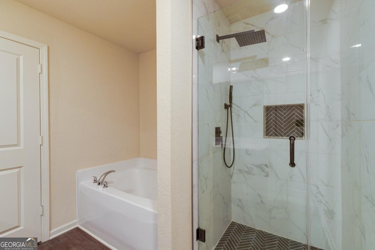410 Winter Chase Pendergrass, GA 30567 - Photo 18 of 24 a bathroom with a bathtub and shower