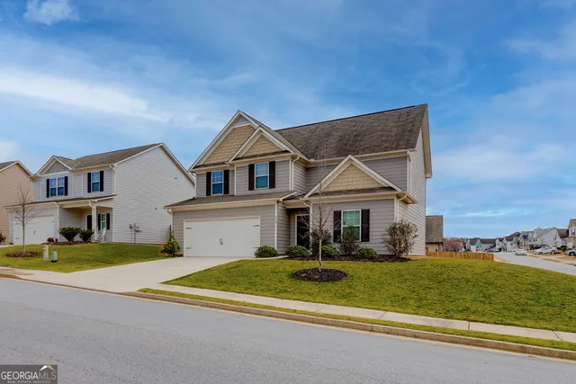 a front view of a house with a yard