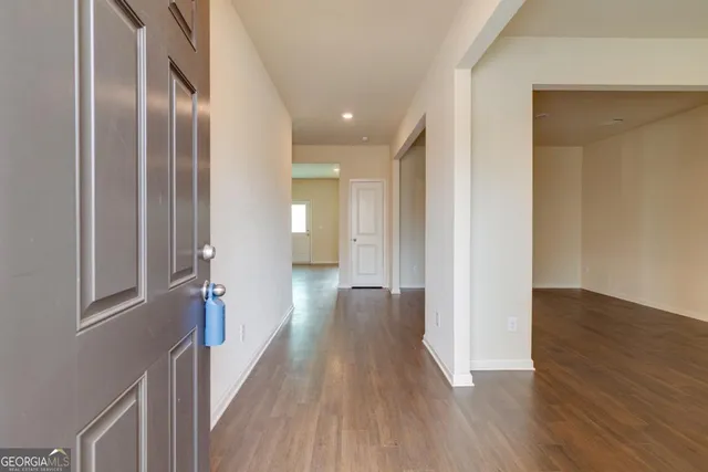 a view of hallway with wooden floor