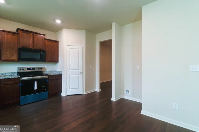 a kitchen with stainless steel appliances granite countertop a stove and a refrigerator