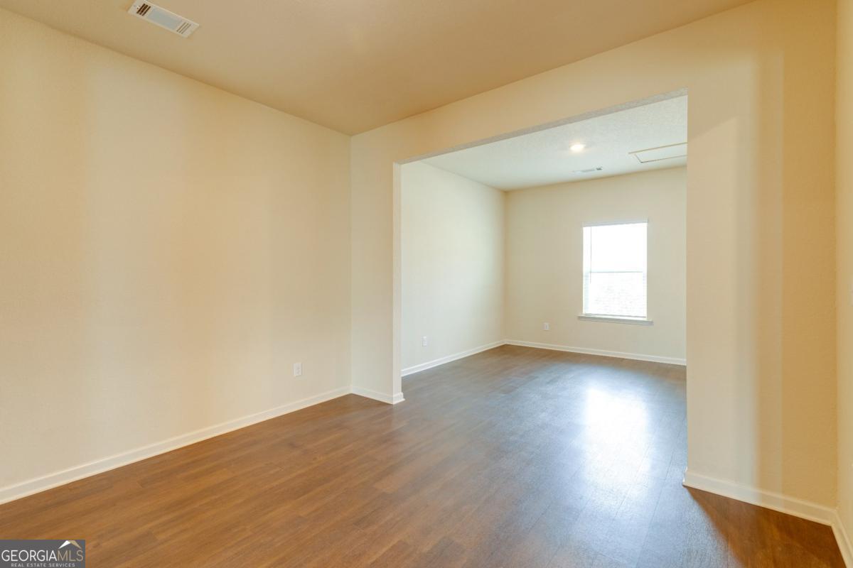 410 Winter Chase Pendergrass, GA 30567 - Photo 9 of 24 an empty room with wooden floor and windows